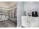 Spacious walk-in pantry with open shelving and custom cabinets and tiled wall at 9183 W Foothill Dr, Peoria, AZ 85383