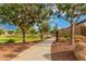Scenic walking path with mature trees and manicured landscaping, providing a tranquil setting for residents to enjoy at 9183 W Foothill Dr, Peoria, AZ 85383