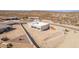 Aerial view of a modern home showing the desert landscaping, concrete driveway, garage, and mountain views at 935 Calle Azul --, Wickenburg, AZ 85390