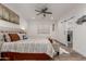 Comfortable bedroom with a sliding barn door leading to a closet, complete with a ceiling fan at 935 Calle Azul --, Wickenburg, AZ 85390