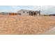 Modern home with a stucco exterior, attached garage and block wall, with a sandy, desert landscape at 935 Calle Azul --, Wickenburg, AZ 85390