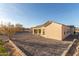 The exterior of this home features neutral stucco and clean lines at 9357 W Canyon Verde Dr, Casa Grande, AZ 85194