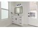 Bathroom includes a framed mirror, a vanity with drawers, and bright natural lighting at 9357 W Canyon Verde Dr, Casa Grande, AZ 85194