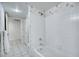 Cozy bathroom featuring a bathtub with white tiles, a shower and a light-colored tile floor at 9460 E Mission Ln # 203, Scottsdale, AZ 85258