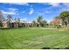 Well-manicured green space between buildings showcases lush lawns and mature trees at 9460 E Mission Ln # 203, Scottsdale, AZ 85258