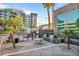 Outdoor BBQ area with grills and a dining table set against a modern building backdrop at 1 E Lexington Ave # 1211, Phoenix, AZ 85012