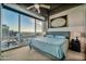 A modern bedroom with a large window offering city views at 1 E Lexington Ave # 1211, Phoenix, AZ 85012