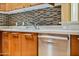 Modern kitchen sink and counter with stainless steel dishwasher and wood cabinets at 1 E Lexington Ave # 1211, Phoenix, AZ 85012