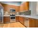 Well-equipped kitchen with modern appliances, countertops and wood cabinets at 1 E Lexington Ave # 1211, Phoenix, AZ 85012