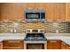 Close-up of a kitchen with stainless steel appliances and modern cabinets at 1 E Lexington Ave # 1211, Phoenix, AZ 85012