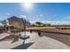 Back patio with chairs and table overlooking common grassy area, ideal for outdoor dining at 11265 E Laguna Azul Cir, Mesa, AZ 85209