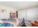 Comfortable bedroom with a decorative quilt, closet and a neutral color scheme at 11265 E Laguna Azul Cir, Mesa, AZ 85209