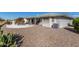 Back exterior showcasing desert landscaping and backyard patio with seating at 11265 E Laguna Azul Cir, Mesa, AZ 85209