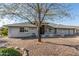 Inviting home with natural stone accents and mature landscaping at 11265 E Laguna Azul Cir, Mesa, AZ 85209