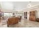 Open living room with tile floors, built-in shelving, and comfortable seating at 11265 E Laguna Azul Cir, Mesa, AZ 85209