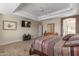 Large main bedroom with a ceiling fan, tile floors, and a serene atmosphere at 11265 E Laguna Azul Cir, Mesa, AZ 85209