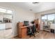 Bright office space with a wooden desk, neutral walls, and a window offering natural light at 11265 E Laguna Azul Cir, Mesa, AZ 85209