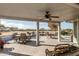 Covered patio with seating area and ceiling fan, perfect for outdoor entertaining at 11265 E Laguna Azul Cir, Mesa, AZ 85209