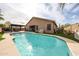 Enjoy this beautiful backyard with a sparkling pool, covered patio, outdoor kitchen and lush green grass at 12622 W Avalon Dr, Avondale, AZ 85392