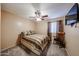 Cozy bedroom boasts neutral color scheme, ceiling fan, plush carpet and a rocking chair at 12622 W Avalon Dr, Avondale, AZ 85392