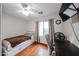 Cozy bedroom with hardwood floors, a built-in storage bed, and a ceiling fan at 12622 W Avalon Dr, Avondale, AZ 85392