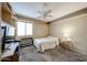 Cozy bedroom with carpet floors, natural light, and built-in shelving for storage at 12622 W Avalon Dr, Avondale, AZ 85392