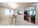 Bright dining room with wood table and white chairs shows view into living area at 12622 W Avalon Dr, Avondale, AZ 85392