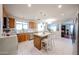 Well-lit kitchen with tile flooring, a kitchen island with bar seating, and modern stainless steel appliances at 12622 W Avalon Dr, Avondale, AZ 85392