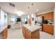 Bright kitchen featuring a kitchen island with bar stools, stainless steel appliances, and an open layout to the dining area at 12622 W Avalon Dr, Avondale, AZ 85392