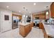 Well-appointed kitchen featuring a central island with seating, stainless steel appliances, and tile flooring at 12622 W Avalon Dr, Avondale, AZ 85392