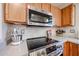 Modern kitchen features stainless steel appliances, granite countertops, and tile backsplash at 12622 W Avalon Dr, Avondale, AZ 85392