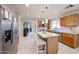 Spacious kitchen featuring a kitchen island with bar seating, stainless steel appliances, and an open floor plan at 12622 W Avalon Dr, Avondale, AZ 85392