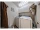 Functional laundry room featuring modern washer and dryer, shelving, and storage space at 12622 W Avalon Dr, Avondale, AZ 85392