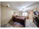 Comfortable carpeted main bedroom with ceiling fan, wooden furniture, and window providing natural light at 12622 W Avalon Dr, Avondale, AZ 85392