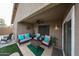 Relaxing covered patio with comfortable seating, a ceiling fan, and lush green artificial turf at 12622 W Avalon Dr, Avondale, AZ 85392