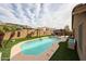 Sparkling pool with artificial turf surround, complemented by a pergola and lounge area for outdoor enjoyment at 12622 W Avalon Dr, Avondale, AZ 85392