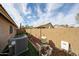 Side yard featuring garden beds, an AC unit, and a pool filtration system, enclosed by block wall fencing at 12622 W Avalon Dr, Avondale, AZ 85392