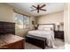 Comfortable bedroom with a large window, ceiling fan, and stylish furniture at 13108 N 91St N Ln, Peoria, AZ 85381