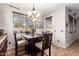 Cozy eat-in dining area features a chandelier, a wooden table, and warm, neutral colors with lots of natural light at 13108 N 91St N Ln, Peoria, AZ 85381