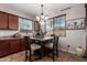 Cozy eat-in dining area features a chandelier, a wooden table, and warm, neutral colors with lots of natural light at 13108 N 91St N Ln, Peoria, AZ 85381