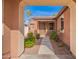 Inviting entryway with a decorative front door and desert landscaping in a neutral color palette at 13108 N 91St N Ln, Peoria, AZ 85381