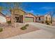 Charming single-story home with stone accents, a two-car garage, and desert landscaping at 13108 N 91St N Ln, Peoria, AZ 85381