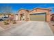 Charming single-story home with stone accents, a two-car garage, and desert landscaping at 13108 N 91St N Ln, Peoria, AZ 85381