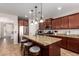 Spacious kitchen featuring dark cabinets, stainless steel appliances, granite countertops, and an island with seating at 13108 N 91St N Ln, Peoria, AZ 85381