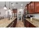 Spacious kitchen featuring dark cabinets, stainless steel appliances, granite countertops, and a walk in pantry at 13108 N 91St N Ln, Peoria, AZ 85381