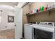 Functional laundry room with modern appliances and storage shelves at 13108 N 91St N Ln, Peoria, AZ 85381