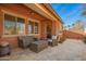 Covered patio with wicker furniture creates a cozy outdoor living space and tiled flooring at 13108 N 91St N Ln, Peoria, AZ 85381