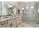 Beautiful bathroom featuring double sinks, granite countertops and a glass enclosed walk-in shower at 15233 W Baden St, Goodyear, AZ 85338