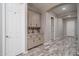 Hallway features built in cabinets with counter space, storage drawers and light grey walls at 15233 W Baden St, Goodyear, AZ 85338