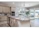 Open kitchen featuring a large island with granite countertops and stainless steel appliances at 15233 W Baden St, Goodyear, AZ 85338